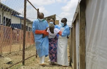 Afrique / Ebola: Plus de 10000 cas confirmés… Des professionnels de santé viennent en aide à une patiente déclarée guérie du virus Ebola à Beni, RDC, le 27 octobre 2026 | Photo: AP